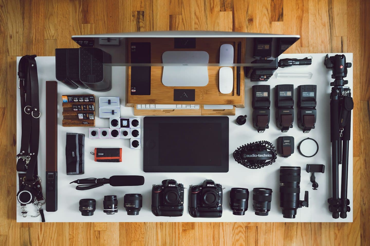 Organized photography equipment and computer accessories on a desk.